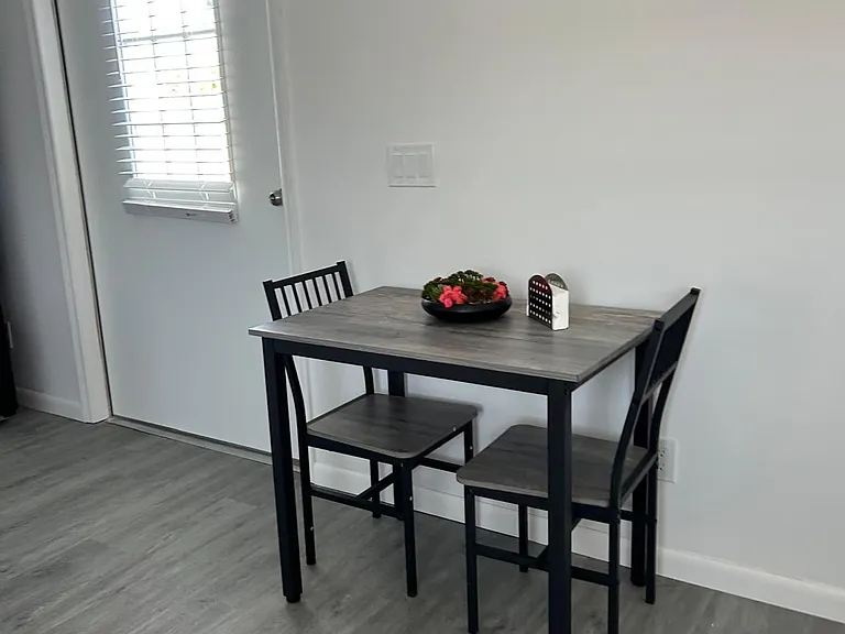 Charming dining space with stylish decor and seating for two.