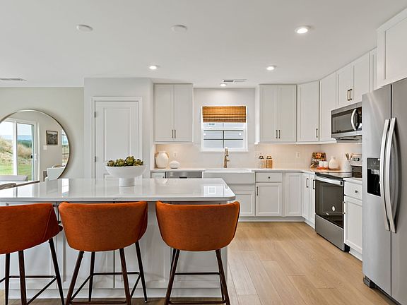 Modern kitchen with a large island in a South Brook single-level home in Inwood, WV, designed for co