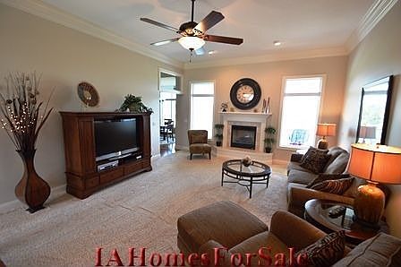 Living Room with 5 step crown molding and remote control gas fireplace with blower