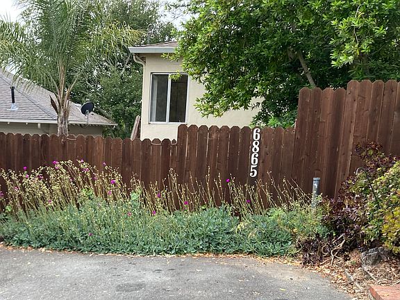 Front of house from the street with parking area.