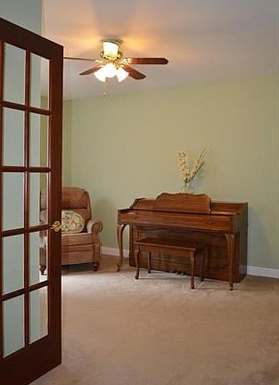 Den off the foyer through double French doors!