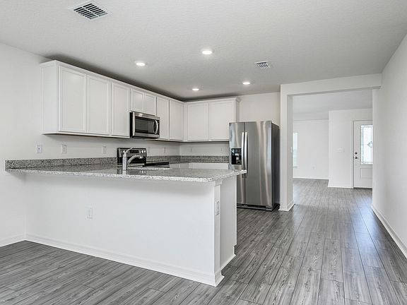 The kitchen is chef-ready with stainless steel appliances