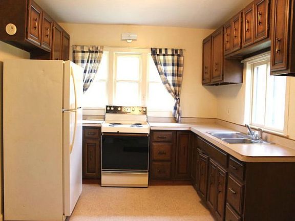 Updated kitchen with new vinyl flooring and updated countertops.
