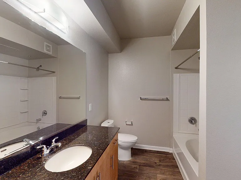 Apartment Bathroom with large soaking tub, Double Sink and Hardwood.