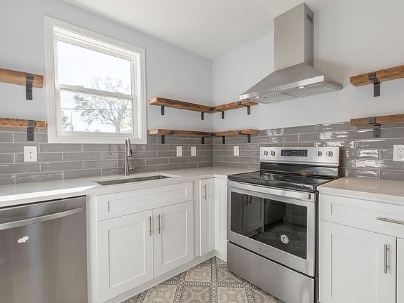 kitchen, all stainless new appliances: stove, fridge, dishwasher, range hood etc...