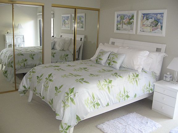 The master bedroom has a deck off to the side and ample storage space