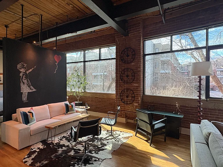 The den provides an intimate conversation and work/study area within the large loft space