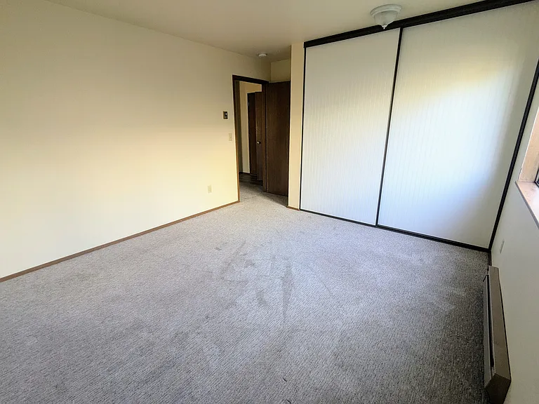 Bedroom with large closet and window