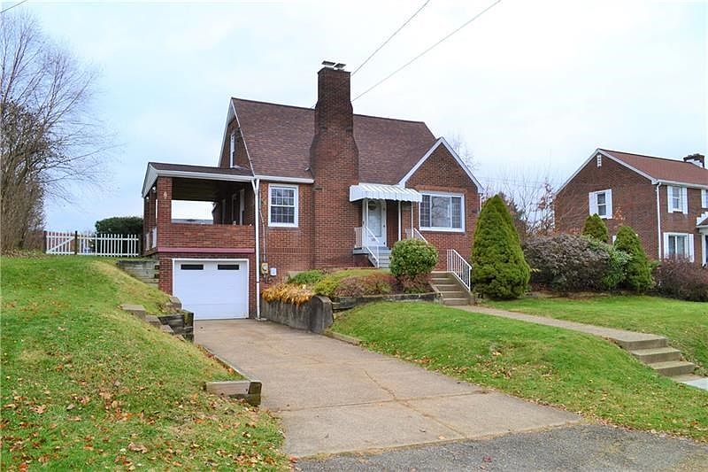Front street view, cement driveway, covered side porch.