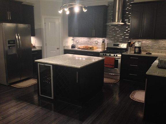 Gas stove and oven, wine fridge, granite counters