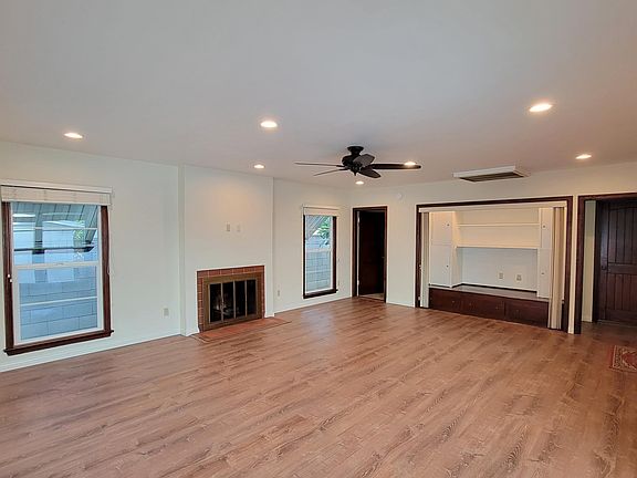 Living room showing storage area on the right. All the ceiling lights were replaced by flush mounted LED light units. Please note the installed Rigid Vinyl flooring planks. were installed on top