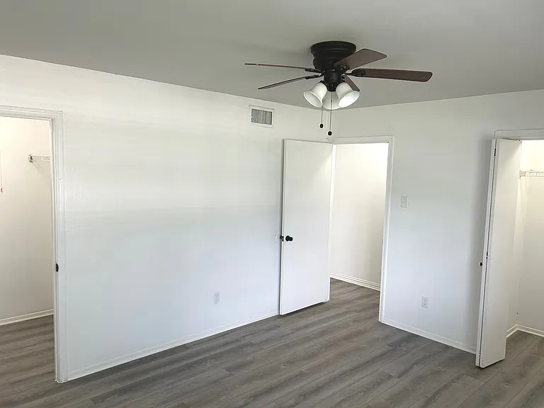 Main bedroom with two closets and ceiling fan