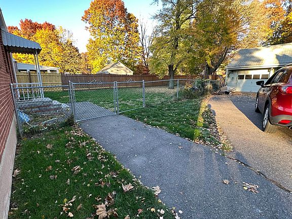Back exterior of house with detached two car garage.