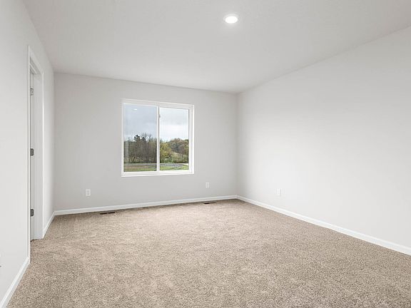 The master bedroom is spacious with a large vanity.