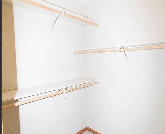 Spacious walk-in closet with abundant room for clothing, shoes, and accessories.