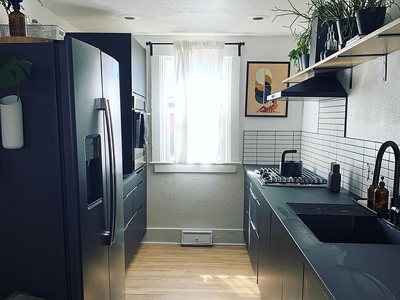 Updated galley kitchen with new side by side fridge/freezer