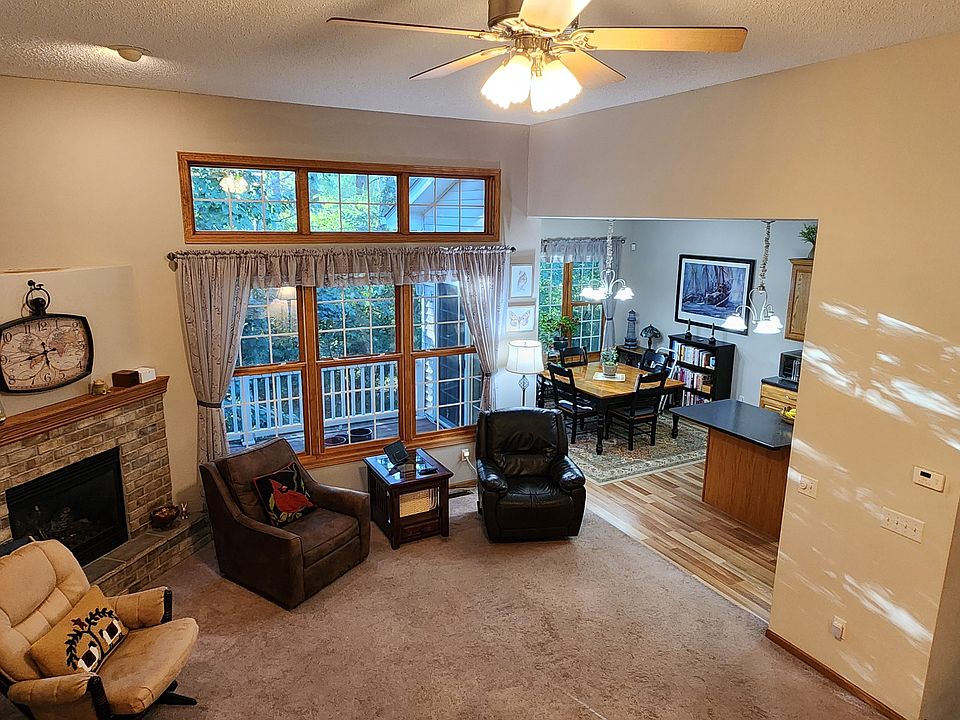 Living room, dining room, and deck (through the window) from the loft. Sun filtering through the woods.