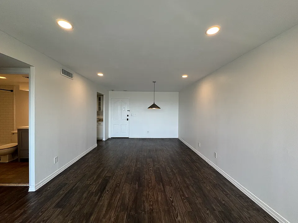 Updated living/dining room features dimmable, efficient LED lighting, new roller shades, and luxury vinyl flooring.