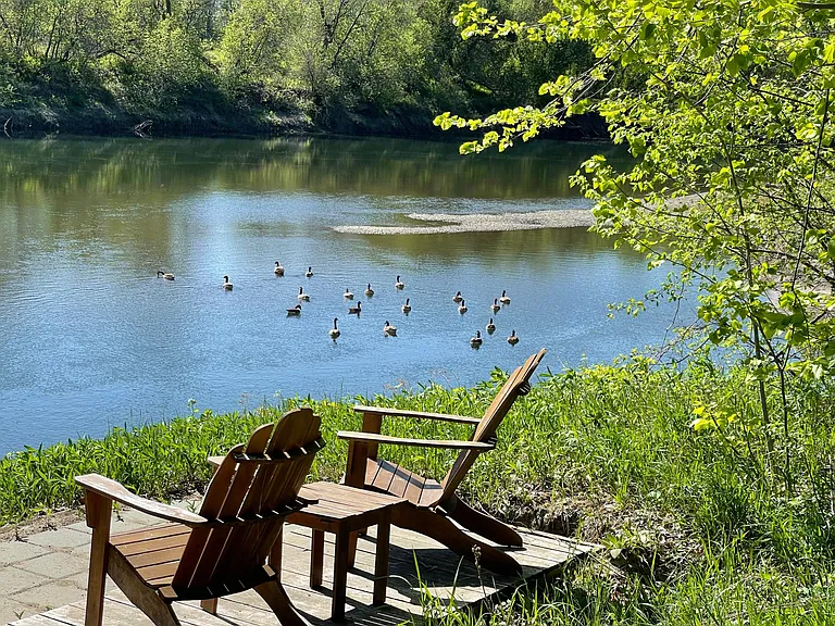 Seating area overlooking the Winooski River during summer months.