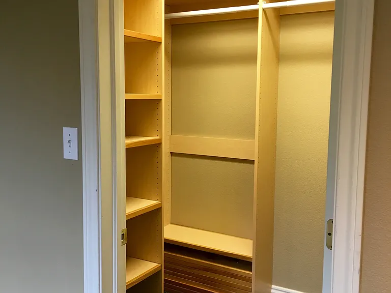 Walk-in closed with fully adjustable handing bar and shelves.