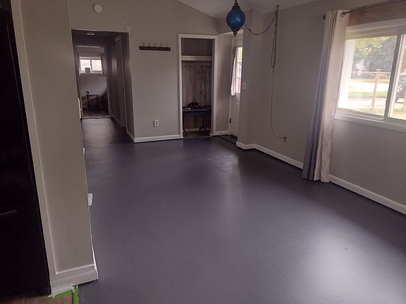 Front door into living area. Looking down the hall towards the large bedroom.