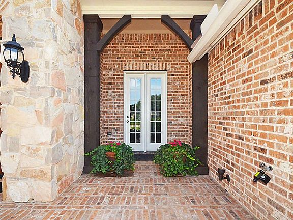 THERE ARE BEAUTIFUL TOUCHES THROUGH OUT! THE FRENCH DOORS LEADING TO THE DINING ROOM ARE SURROUNDED BY CUSTOM WOOD BEAMS!