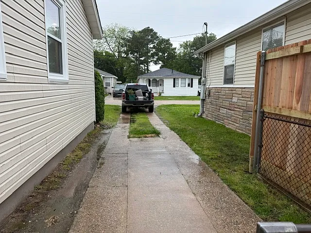 Driveway leads to rear yard access.