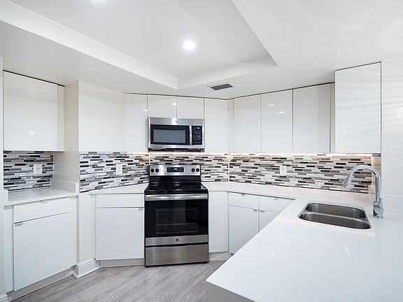 Modern kitchen with stainless steel appliances, granite countertops and designer cabinets