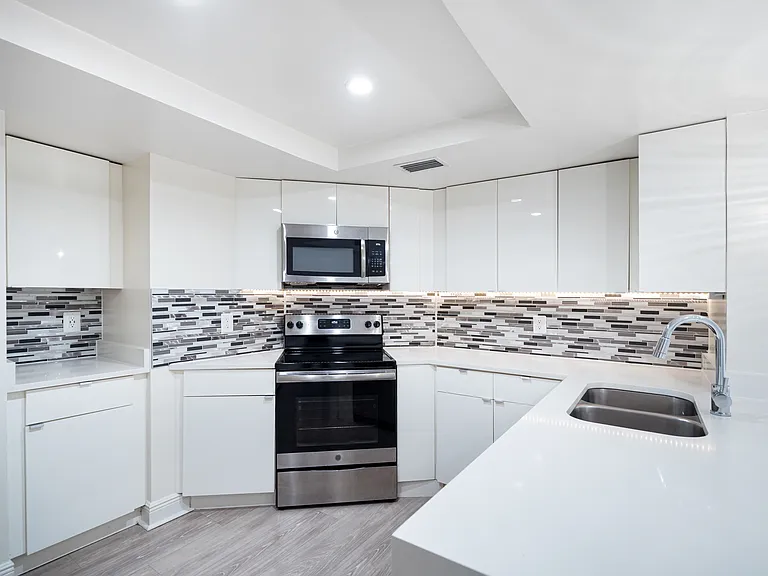 Modern kitchen with stainless steel appliances, granite countertops and designer cabinets