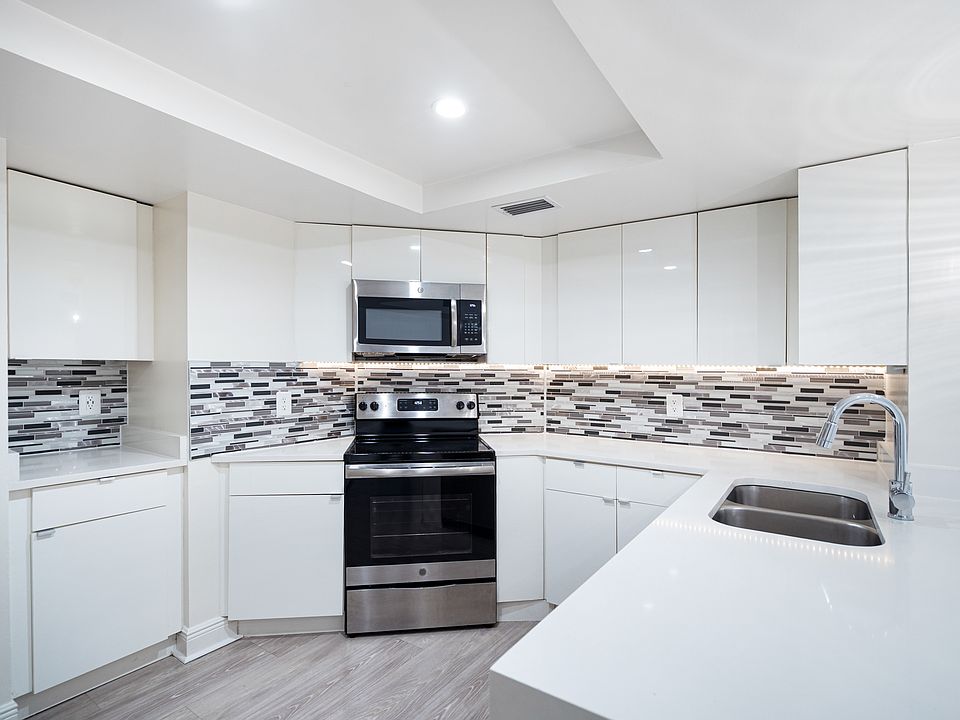 Modern kitchen with stainless steel appliances, granite countertops and designer cabinets
