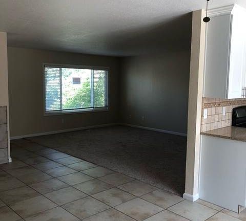 Newly carpeted living room taken from tiled family room.