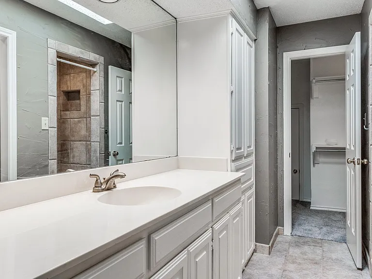 One side of master bathroom with view into master closet