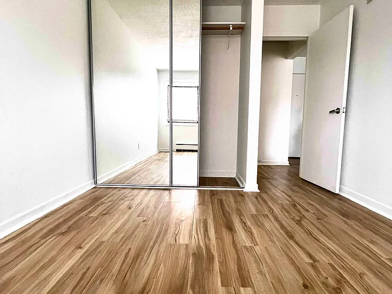 Bedroom closet, fits dresser under hanging items and has floor to ceiling mirrors