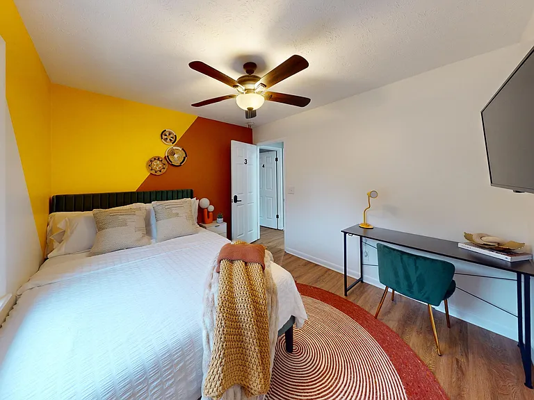 Queen Bedroom with a desk and a TV