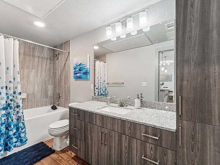 A sleek, updated bathroom in a model unit at The Broadway, Houston, TX.