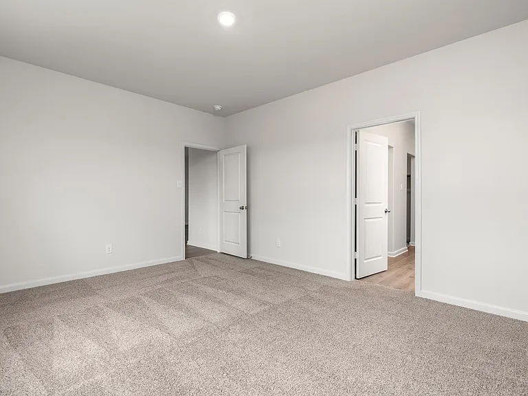The master suite has a large bedroom, ensuite bathroom and a walk-in closet.