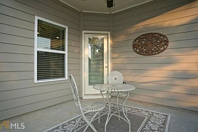 Covered patio leading to fenced backyard with gas hookup