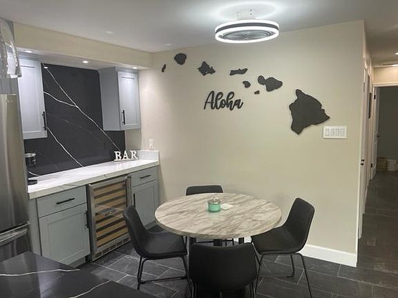 Dining area! With beautiful Aloha wood art work in the background.