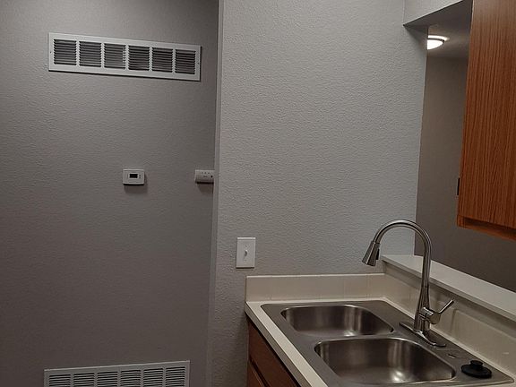 Kitchen and hall featuring new LED lighting and new pull down kitchen faucet.