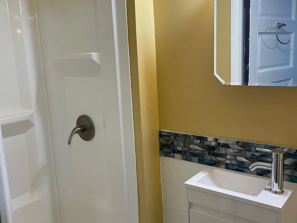 First floor bathroom off kitchen with shower.