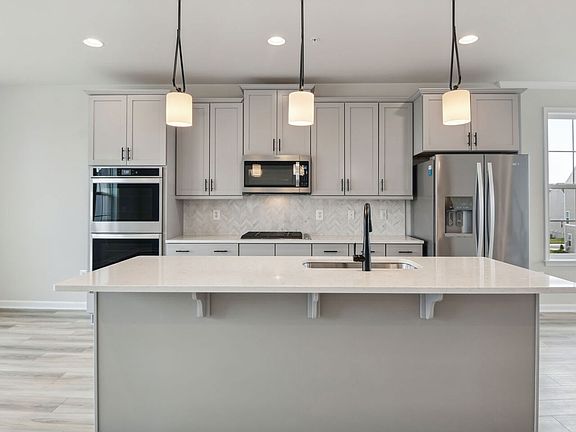 Island kitchen in a DRB Homes Davenport Plan at the Laurel Overlook community.