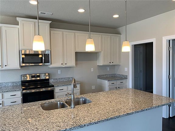 Shaker style cabinets, granite counter tops with undermount sink