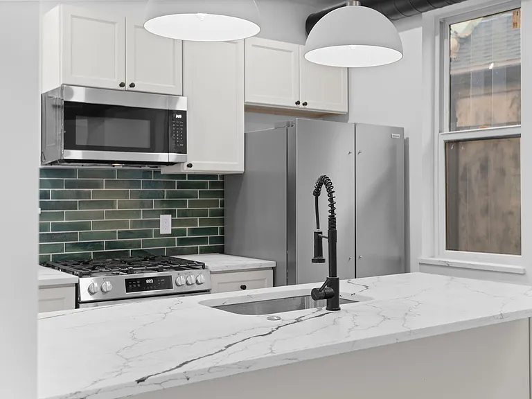 Chef's kitchen _ gas range with emerald green subway tile backsplash