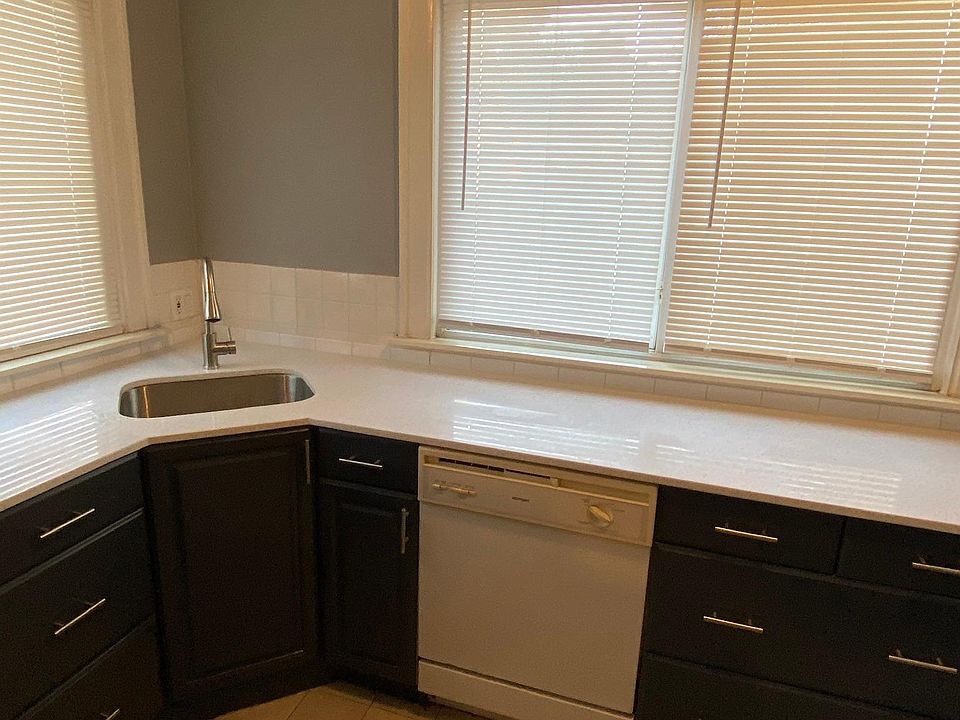 Kitchen with new quartz countertop, stainless steel sink, and faucet