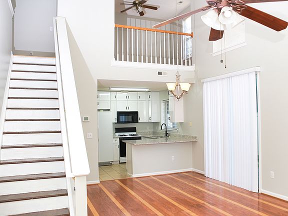 Living area with soaring ceilings and a view of the loft above