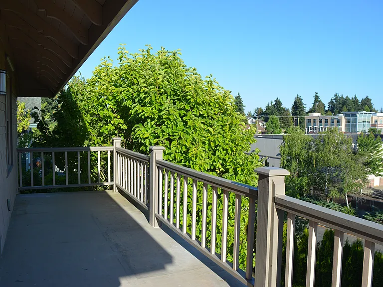 Deck overlooks 6th Ave; behind the tree is Mount Rainier