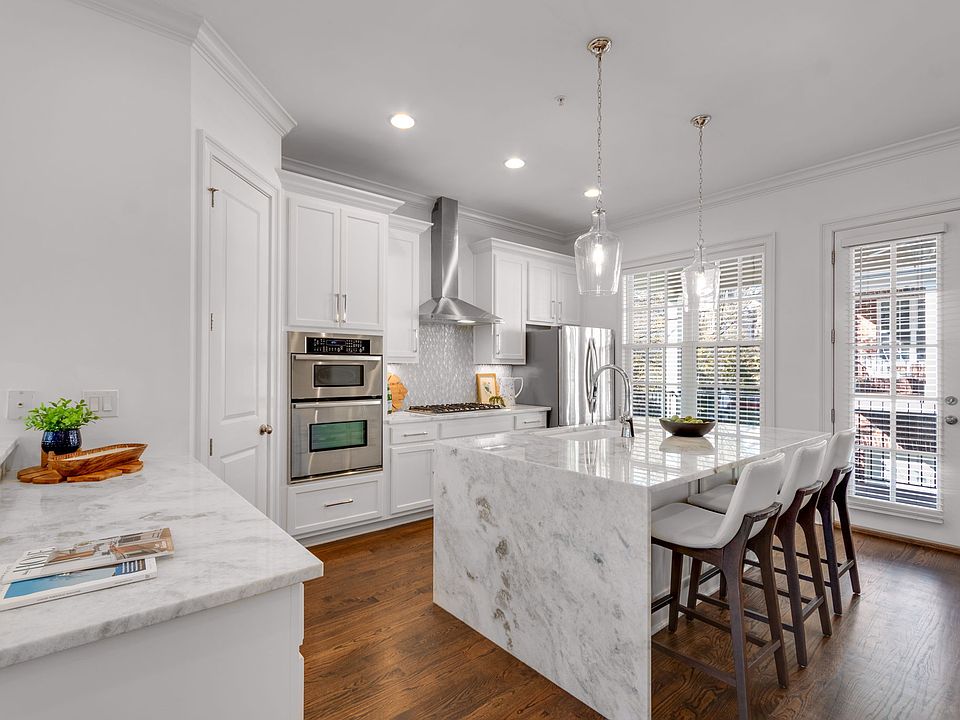 Updated kitchen with waterfall marble island and new 6-burner Viking cooktop