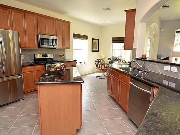  From the foyer, and formal dining is the stunning kitchen with granite counters, island, stainless appliances and tons of cabinet space.
