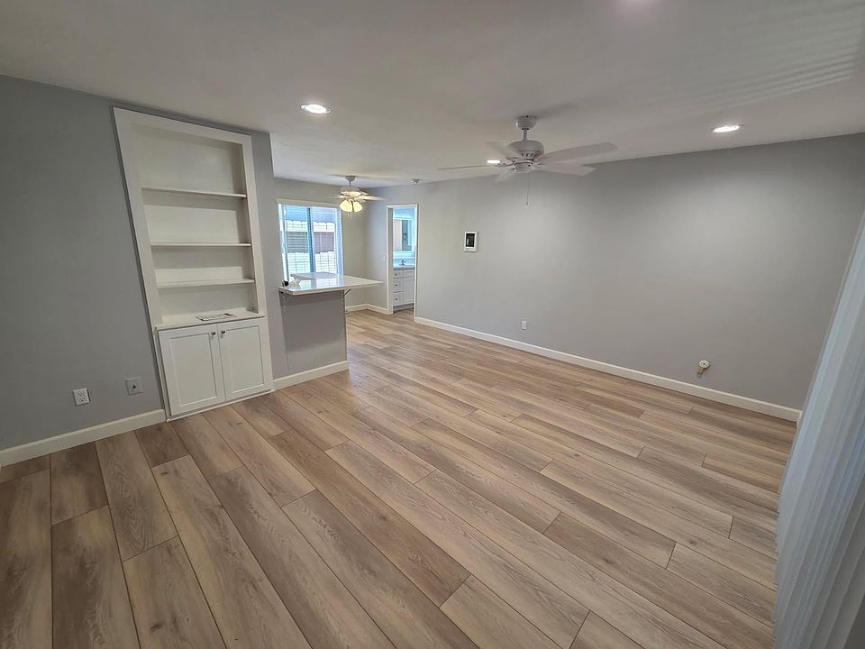 Spacious living room with a built in book shelf and new LVP flooring.