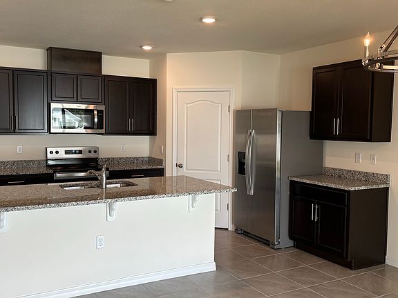 Beautiful kitchen with big island, stainless steel appliances, undermount sink, and granite countertops.